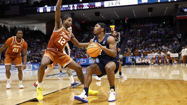 Mar 19, 2025; Dayton, OH, USA; Xavier Musketeers guard Ryan Conwell (7) dribbles the ball defended by Texas Longhorns guard Tramon Mark (12) in the second half at UD Arena.