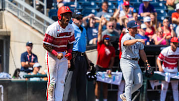 Jun 15, 2025; Omaha, Neb, USA; Louisville Cardinals left fielder Zion Rose (32) celebrates after scoring on a RBI single against the Arizona Wildcats during the eighth inning at Charles Schwab Field. Mandatory Credit: Dylan Widger-Imagn Images