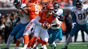 Cincinnati Bengals quarterback Joe Burrow (9) is wrapped up as he scrambles in the first quarter of the NFL Week 2 game between the Cincinnati Bengals and the Jacksonville Jaguars at Paycor Stadium in downtown Cincinnati on Sunday, Sept. 14, 2025. The Jaguars led 17-10 at halftime.