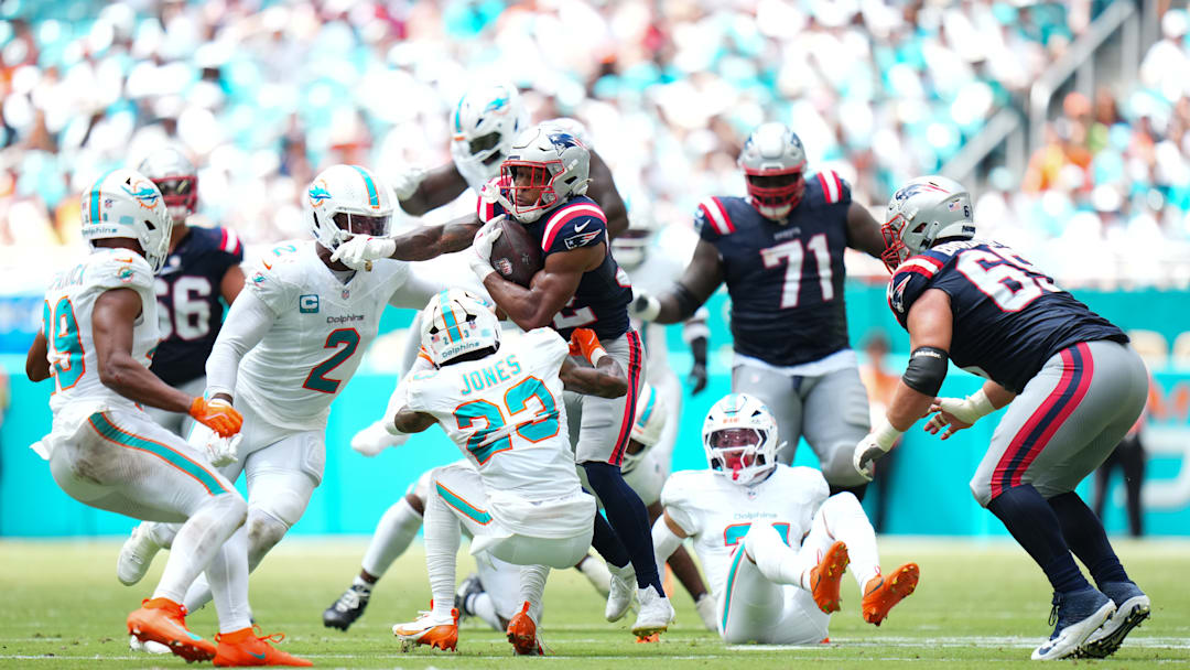 Sept 14, 2025; Miami, Florida, USA; New England Patriots Rookie RB TreVeyon Henderson (32) barrels through a defender in New England's Week 2 matchup against the Miami Dolphins. Mandatory Credit: Rich Storry-Getty Images
