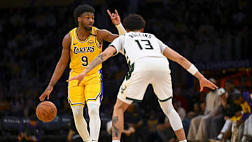 Los Angeles Lakers guard Bronny James looks to pass against Milwaukee Bucks guard Ryan Rollins.