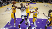 Oct 24, 2025; Los Angeles, California, USA; Los Angeles Lakers center Deandre Ayton (5) shoots the ball against Los Angeles Lakers guard Gabe Vincent (7), guard Luka Doncic (77) and forward Rui Hachimura (28) in the second half at Crypto.com Arena. Mandatory Credit: Kirby Lee-Imagn Images