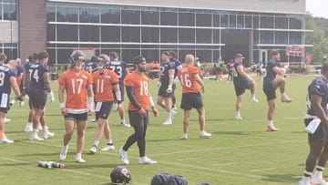 Caleb Williams and the Bears quarterbacks go through stretching prior to Tuesday's fourth practice.