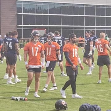 Caleb Williams and the Bears quarterbacks go through stretching prior to Tuesday's fourth practice.