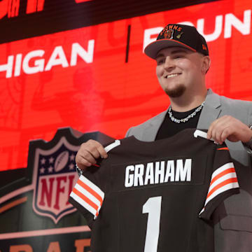 Mason Graham holds a Browns jersey after being drafted.