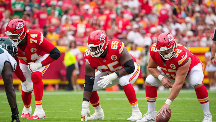 Sep 14, 2025; Kansas City, Missouri, USA; Kansas City Chiefs offensive tackle Jawaan Taylor (74) and guard Trey Smith (65) and center Creed Humphrey (52) at the line of scrimmage against the Philadelphia Eagles during the game at GEHA Field at Arrowhead Stadium. Mandatory Credit: Denny Medley-Imagn Images
