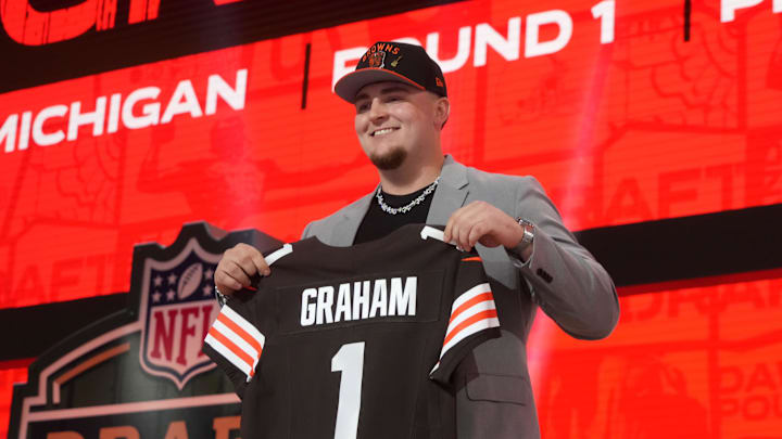 Mason Graham holds a Browns jersey after being drafted.