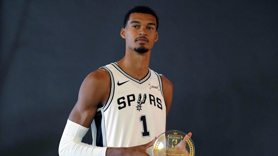 Sep 29, 2025; San Antonio, TX, USA; San Antonio Spurs forward-center Victor Wembanyama (1) holds his Fan Favorite award for Defensive Player of the Year during Media Day at Victory Capital Performance Center in San Antonio. Mandatory Credit: Scott Wachter-Imagn Images