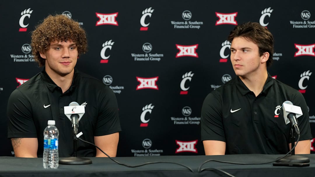 New transfers, tight end Joe Royer (left) and quarterback Brendan Sorsby, take questions during a press conference at the University of Cincinnati   s Fifth Third Arena in Cincinnati on Tuesday, Feb. 13, 2024.