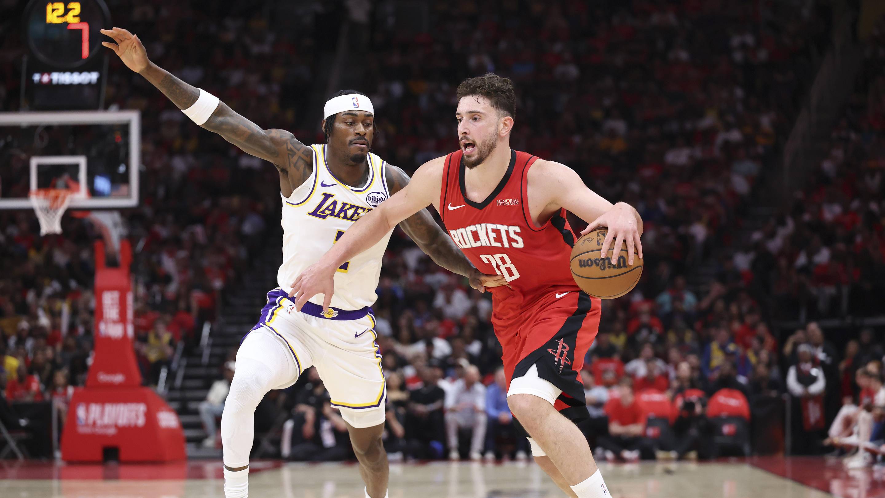 Apr 26, 2026; Houston, Texas, USA; Houston Rockets center Alperen Sengun (28) drives with the ball as Los Angeles Lakers forward Jarred Vanderbilt (2) defends during the first quarter during game four of the first round of the 2026 NBA Playoffs at Toyota Center. Mandatory Credit: Troy Taormina-Imagn Images
