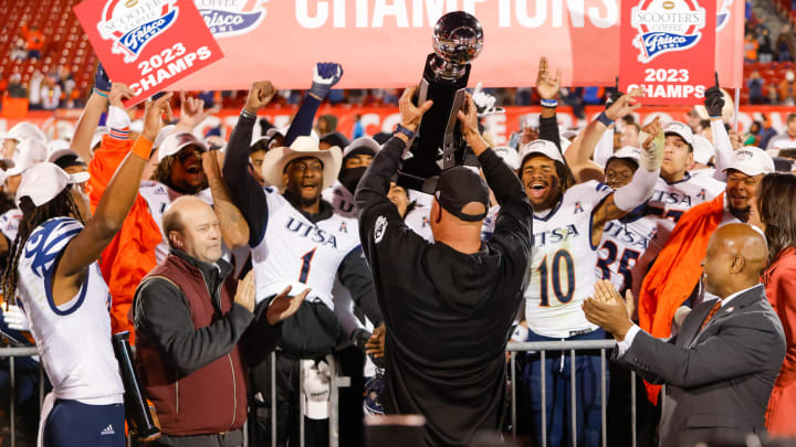 Dec 19, 2023; Frisco, TX, USA; UTSA Roadrunners head coach Jeff Traylor holds the trophy towards his players after winning the Frisco Bowl against the Marshall Thundering Herd at Toyota Stadium. Mandatory Credit: Andrew Dieb-USA TODAY Sports