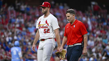 Jun 5, 2025; St. Louis, Missouri, USA;  St. Louis Cardinals starting pitcher Matthew Liberatore (52) walks off the field with a trainer after he was removed from the game with an injury during the fifth inning against the Kansas City Royals at Busch Stadium. Mandatory Credit: Jeff Curry-Imagn Images