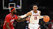 Mar 21, 2025; Cleveland, OH, USA; Alabama Crimson Tide forward Jarin Stevenson (15) dribbles the ball defended by Robert Morris Colonials guard Amarion Dickerson (3) in the first half during the NCAA Tournament First Round at Rocket Arena. 