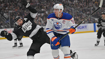 Apr 23, 2025; Los Angeles, California, USA;  Los Angeles Kings defenseman Drew Doughty (8) and Edmonton Oilers center Connor McDavid (97) battle on the ice in the first period of game 2 of the 2025 Stanley Cup Playoffs at Crypto.com Arena. Mandatory Credit: Jayne Kamin-Oncea-Imagn Images