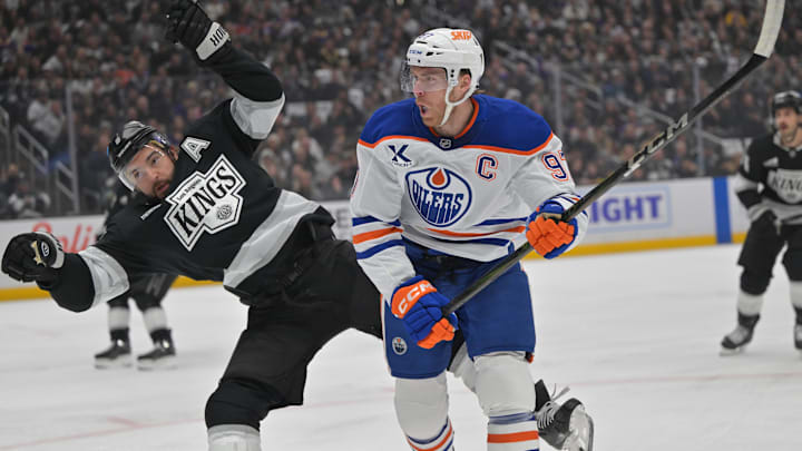 Apr 23, 2025; Los Angeles, California, USA;  Los Angeles Kings defenseman Drew Doughty (8) and Edmonton Oilers center Connor McDavid (97) battle on the ice in the first period of game 2 of the 2025 Stanley Cup Playoffs at Crypto.com Arena. Mandatory Credit: Jayne Kamin-Oncea-Imagn Images