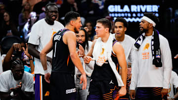 Oct 31, 2025; Phoenix, Arizona, USA;  Phoenix Suns guard Devin Booker (1) and the Suns bench react to a three-point shot by Booker in the second half between the Phoenix Suns and the Utah Jazz at Mortgage Matchup Center. Mandatory Credit: Arianna Grainey-Imagn Images