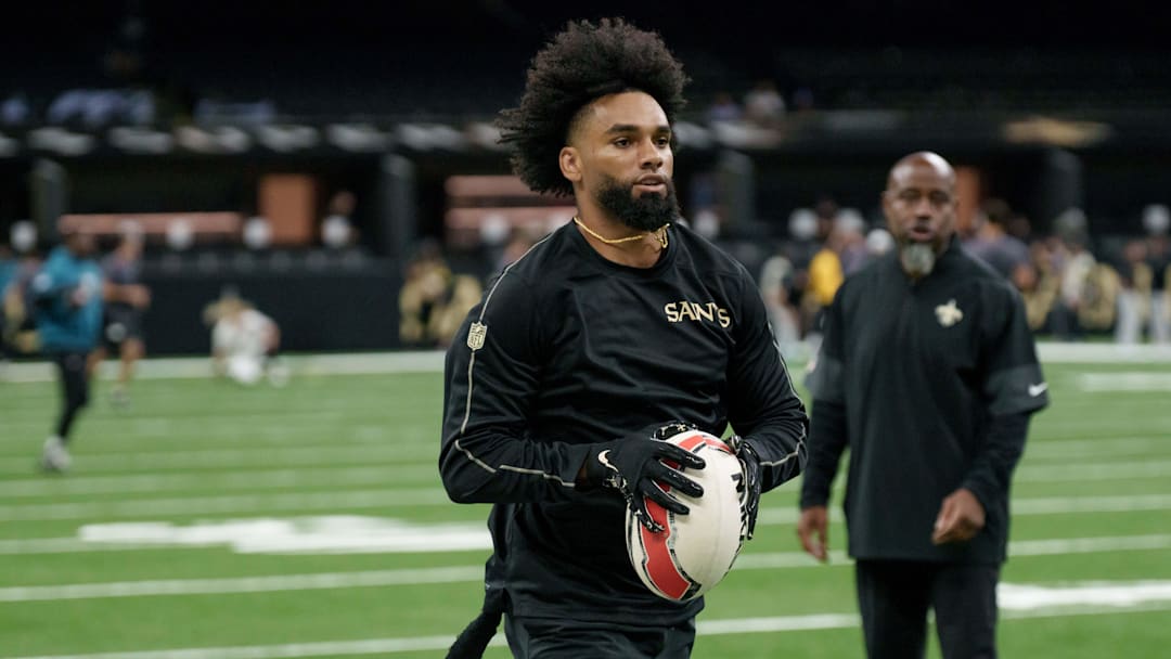 Aug 17, 2025; New Orleans, Louisiana, USA; New Orleans Saints wide receiver Chris Olave (12) warms up with a rugby ball against the Jacksonville Jaguars at Caesars Superdome. Mandatory Credit: Matthew Hinton-Imagn Images