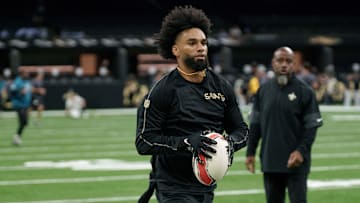 Aug 17, 2025; New Orleans, Louisiana, USA; New Orleans Saints wide receiver Chris Olave (12) warms up with a rugby ball against the Jacksonville Jaguars at Caesars Superdome. Mandatory Credit: Matthew Hinton-Imagn Images