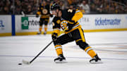 Dec 1, 2024; Boston, Massachusetts, USA; Boston Bruins defenseman Brandon Carlo (25) skates with the puck during the second period of a game against the Montreal Canadiens at TD Garden. Mandatory Credit: Natalie Reid-Imagn Images