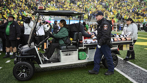 Jaivian Thomas is taken out of Autzen Stadium last season.