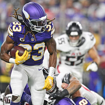 Sep 14, 2025; Minneapolis, Minnesota, USA; Minnesota Vikings running back Aaron Jones Sr. (33) runs the ball during the first half against the Atlanta Falcons at U.S. Bank Stadium.