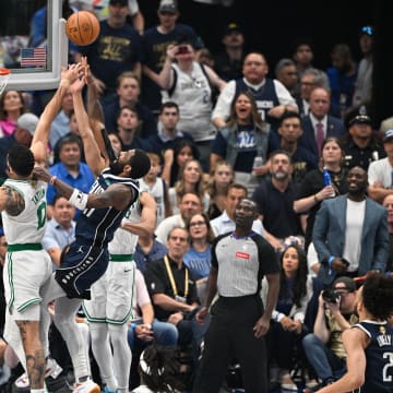 Jun 14, 2024; Dallas, Texas, USA; Dallas Mavericks guard Kyrie Irving (11) shoots over Boston Celtics forward Jayson Tatum (0) and guard Derrick White (9) during the first quarter of game four of the 2024 NBA Finals at American Airlines Center. Mandatory Credit: Jerome Miron-USA TODAY Sports