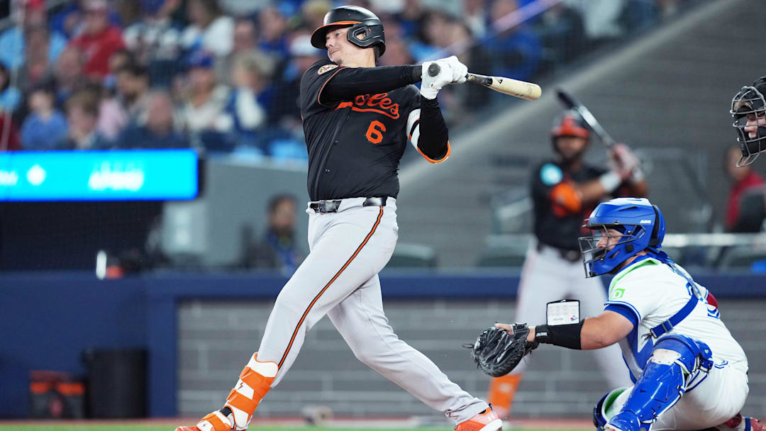 Mar 27, 2025; Toronto, Ontario, CAN; Baltimore Orioles first base Ryan Mountcastle (6) hits a double against the Toronto Blue Jays during the second inning at Rogers Centre. 