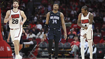 Mar 10, 2025; Houston, Texas, USA; Orlando Magic center Wendell Carter Jr. (34) and Houston Rockets center Alperen Sengun (28) and guard Jalen Green (4) react after a play during the third quarter at Toyota Center. Mandatory Credit: Troy Taormina-Imagn Images