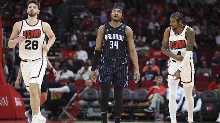 Mar 10, 2025; Houston, Texas, USA; Orlando Magic center Wendell Carter Jr. (34) and Houston Rockets center Alperen Sengun (28) and guard Jalen Green (4) react after a play during the third quarter at Toyota Center. Mandatory Credit: Troy Taormina-Imagn Images