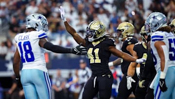Sep 15, 2024; Arlington, Texas, USA; New Orleans Saints running back Alvin Kamara (41) celebrates in front of Dallas Cowboys linebacker Damone Clark (18) after scoring a touchdown  during the first quarter  at AT&T Stadium. Mandatory Credit: Kevin Jairaj-Imagn Images