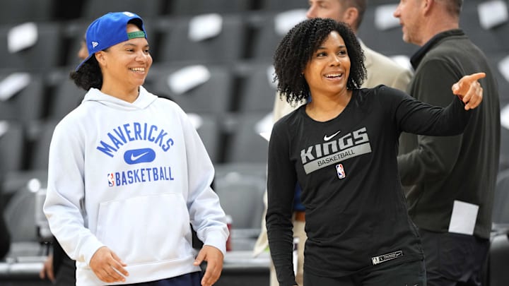 Feb 11, 2023; Sacramento, California, USA; Dallas Mavericks assistant coach Kristi Toliver (left) and Sacramento Kings assistant coach Lindsey Harding (right) talk before the game at Golden 1 Center. Mandatory Credit: Darren Yamashita-Imagn Images