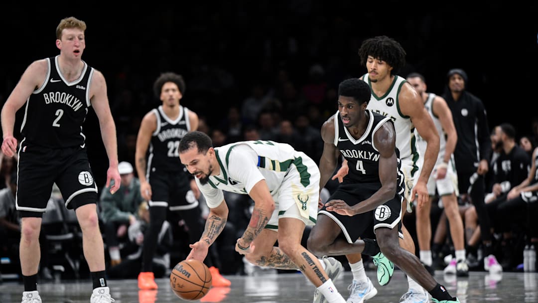 Dec 14, 2025; Brooklyn, New York, USA; Milwaukee Bucks guard Cole Anthony (50) tries to gain control of the ball as Brooklyn Nets guard Drake Powell (4) defends during the second half at Barclays Center. Mandatory Credit: John Jones-Imagn Images