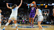 LSU Tigers guard Mikaylah Williams shoots a jump shot against UCLA Bruins center Lauren Betts and forward Gabriela Jaquez.