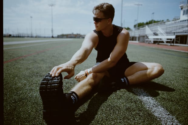 Joe Burrow models black Alo Yoga running shoes.