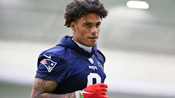 New England Patriots cornerback Christian Gonzalez (0) jogs to the sideline during minicamp held in the WIN Field House at Gillette Stadium.