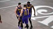 Apr 9, 2025; Dallas, Texas, USA; Los Angeles Lakers guard Luka Doncic (77) and guard Austin Reaves (15) and forward Dorian Finney-Smith (17) celebrate during the fourth quarter against the Dallas Mavericks at the American Airlines Center. Mandatory Credit: Jerome Miron-Imagn Images