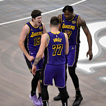 Apr 9, 2025; Dallas, Texas, USA; Los Angeles Lakers guard Luka Doncic (77) and guard Austin Reaves (15) and forward Dorian Finney-Smith (17) celebrate during the fourth quarter against the Dallas Mavericks at the American Airlines Center. Mandatory Credit: Jerome Miron-Imagn Images