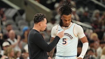 Apr 13, 2025; San Antonio, Texas, USA; San Antonio Spurs interim coach Mitch Johnson talks with guard Stephon Castle (5) during the first half against the Toronto Raptors at Frost Bank Center. Mandatory Credit: Scott Wachter-Imagn Images