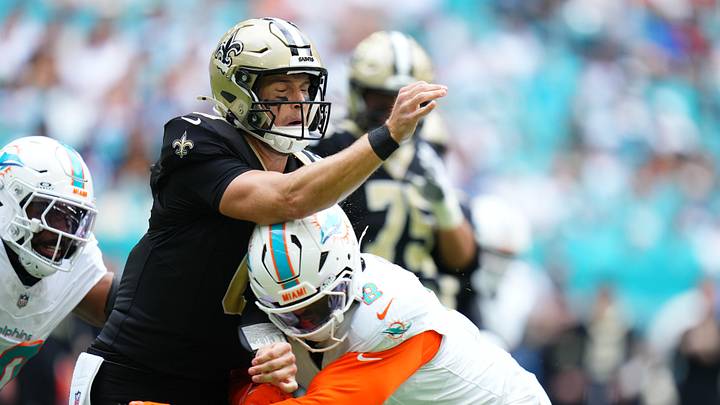 Nov 30, 2025; Miami Gardens, Florida, USA; Miami Dolphins linebacker Matthew Judon (8) puts a hit on New Orleans Saints quarterback Tyler Shough (6) a during the first half at Hard Rock Stadium. Mandatory Credit: Rich Storry-Imagn Images