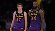 Nov 21, 2024; Los Angeles, California, USA; Los Angeles Lakers guard Austin Reaves (15) and forward LeBron James (23) talk on the court during a stoppage in play against the Orlando Magic at Crypto.com Arena. Mandatory Credit: Jayne Kamin-Oncea-Imagn Images