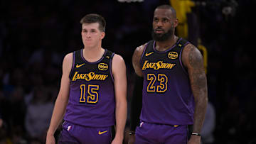 Nov 21, 2024; Los Angeles, California, USA; Los Angeles Lakers guard Austin Reaves (15) and forward LeBron James (23) talk on the court during a stoppage in play against the Orlando Magic at Crypto.com Arena. Mandatory Credit: Jayne Kamin-Oncea-Imagn Images