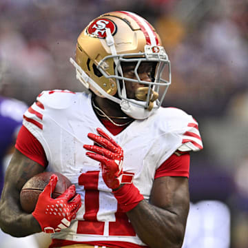 Sep 15, 2024; Minneapolis, Minnesota, USA; San Francisco 49ers wide receiver Brandon Aiyuk (11) looks for yards after the catch against the Minnesota Vikings during the first quarter U.S. Bank Stadium. Mandatory Credit: Jeffrey Becker-Imagn Images