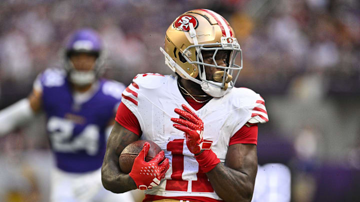 Sep 15, 2024; Minneapolis, Minnesota, USA; San Francisco 49ers wide receiver Brandon Aiyuk (11) looks for yards after the catch against the Minnesota Vikings during the first quarter U.S. Bank Stadium. Mandatory Credit: Jeffrey Becker-Imagn Images