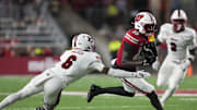 Aug 28, 2025; Madison, Wisconsin, USA;  Wisconsin Badgers wide receiver Eugene Hilton Jr. (13) rushes with the football against Miami (OH) RedHawks defensive back Adrian Walker Jr. (6) during the third quarter at Camp Randall Stadium. Mandatory Credit: Jeff Hanisch-Imagn Images