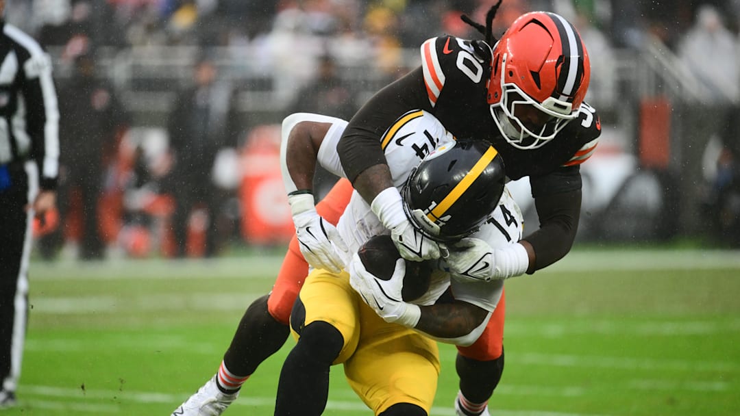 Dec 28, 2025; Cleveland, Ohio, USA; Cleveland Browns linebacker Devin Bush (30) tackles Pittsburgh Steelers running back Kenneth Gainwell (14) in the first quarter at Huntington Bank Field. Mandatory Credit: Ken Blaze-Imagn Images