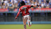 Aug 31, 2025; Los Angeles, California, USA;  Arizona Diamondbacks left fielder Corbin Carroll (7) celebrates as he rounds the bases on a three-run home run during the eighth inning off Los Angeles Dodgers relief pitcher Tanner Scott (66) at Dodger Stadium. Mandatory Credit: Jayne Kamin-Oncea-Imagn Images