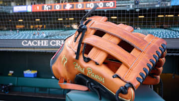 May 20, 2025; San Francisco, California, USA; The baseball glove of San Francisco Giants left fielder Heliot Ramos (17) rests on the dugout rail before the game between the San Francisco Giants and the Kansas City Royals at Oracle Park. Mandatory Credit: Robert Edwards-Imagn Images