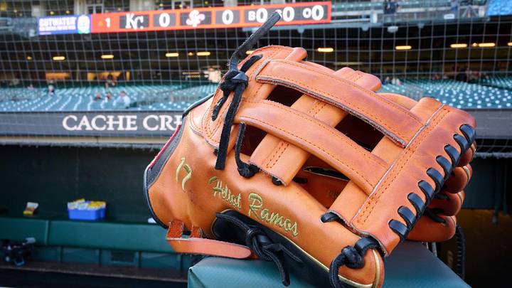 May 20, 2025; San Francisco, California, USA; The baseball glove of San Francisco Giants left fielder Heliot Ramos (17) rests on the dugout rail before the game between the San Francisco Giants and the Kansas City Royals at Oracle Park. Mandatory Credit: Robert Edwards-Imagn Images