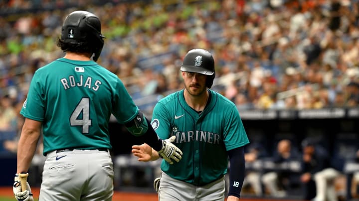 Seattle Mariners catcher Mitch Garver (right) is greeted by third baseman Josh Rojas (4) after scoring a run last week against the Rays at Tropicana Field.