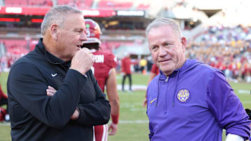 Oct 19, 2024; Fayetteville, Arkansas, USA; Arkansas Razorbacks head coach Sam Pittman talks to LSU Tigers head coach Brian Kelly prior to a game at Donald W. Reynolds Razorback Stadium. Mandatory Credit: Nelson Chenault-Imagn Images